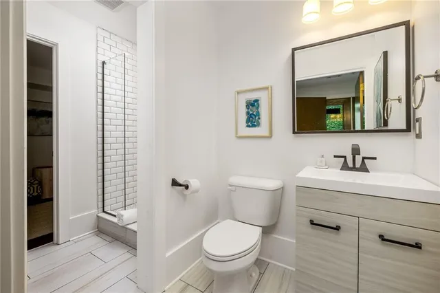 a bathroom with a toilet a sink and mirror