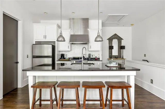 a kitchen with kitchen island granite countertop a table and chairs in it