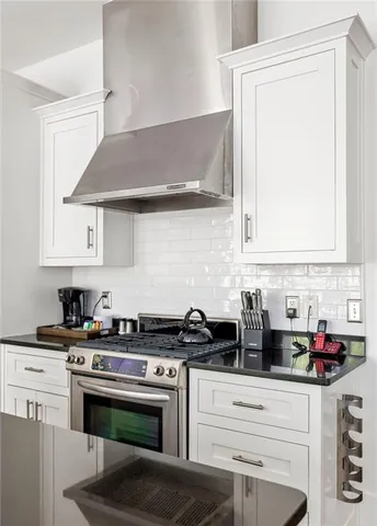 a kitchen with stainless steel appliances granite countertop a stove and a cabinets