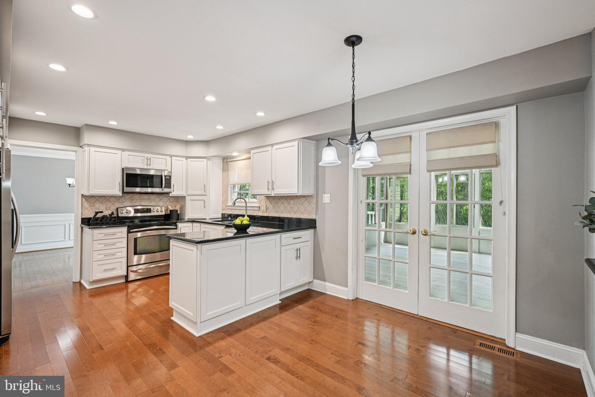 2 Keston Place Voorhees, NJ 08043 - Photo 14 of 83 a kitchen with stainless steel appliances granite countertop a refrigerator a stove a sink dishwasher a oven with white cabinets and wooden floor
