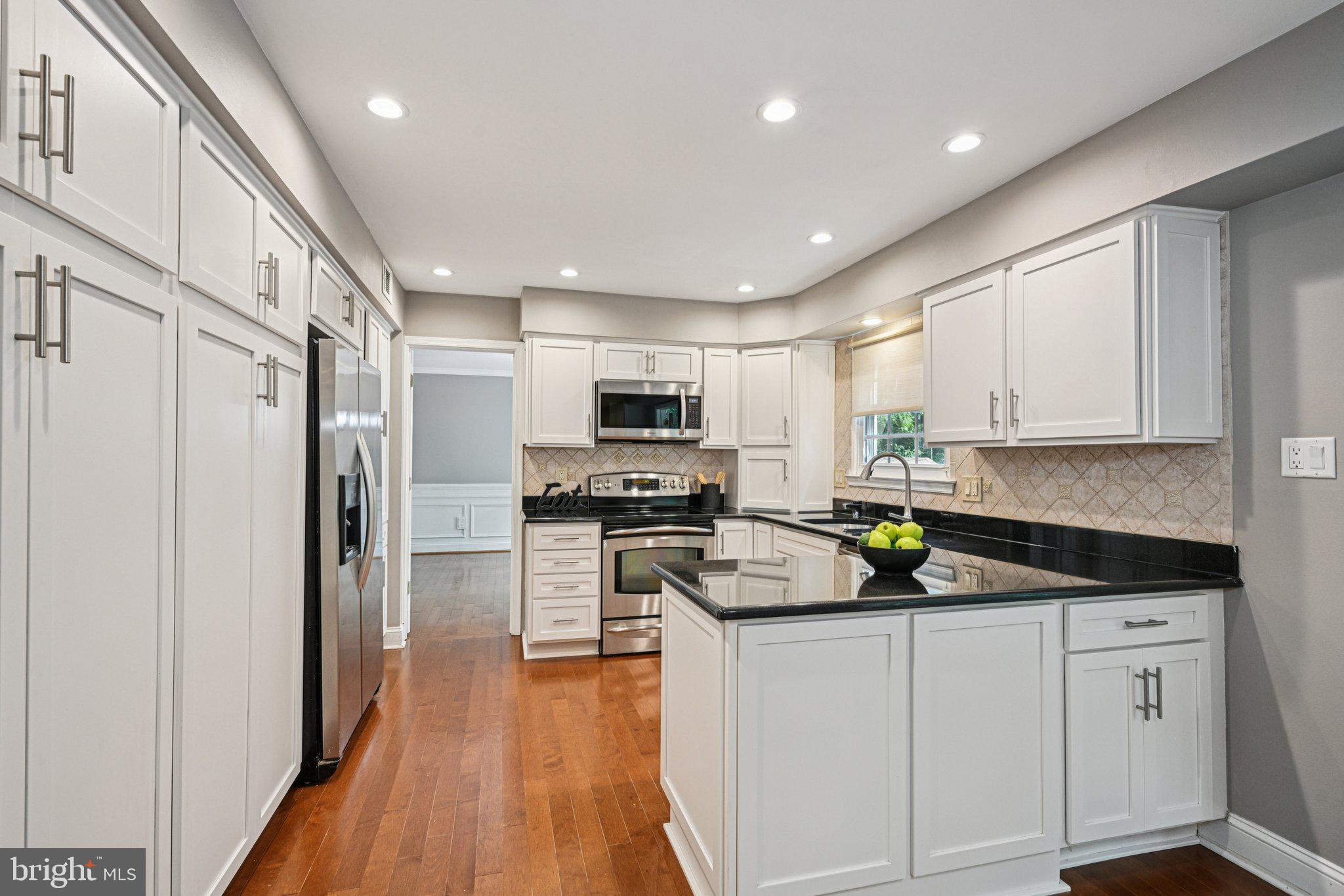 2 Keston Place Voorhees, NJ 08043 - Photo 15 of 83 a kitchen with white cabinets and stainless steel appliances