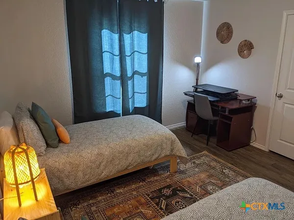 a bedroom with a bed and lamps