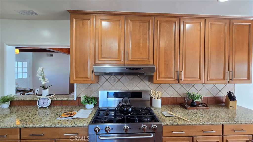 1111 Arbor Dell Road Los Angeles, CA 90041 - Photo 12 of 42 a kitchen with granite countertop cabinets and stainless steel appliances