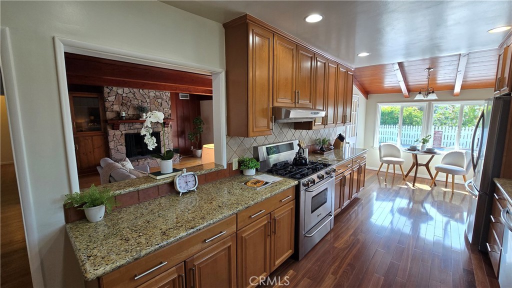 1111 Arbor Dell Road Los Angeles, CA 90041 - Photo 14 of 42 a kitchen with sink a stove and wooden cabinets