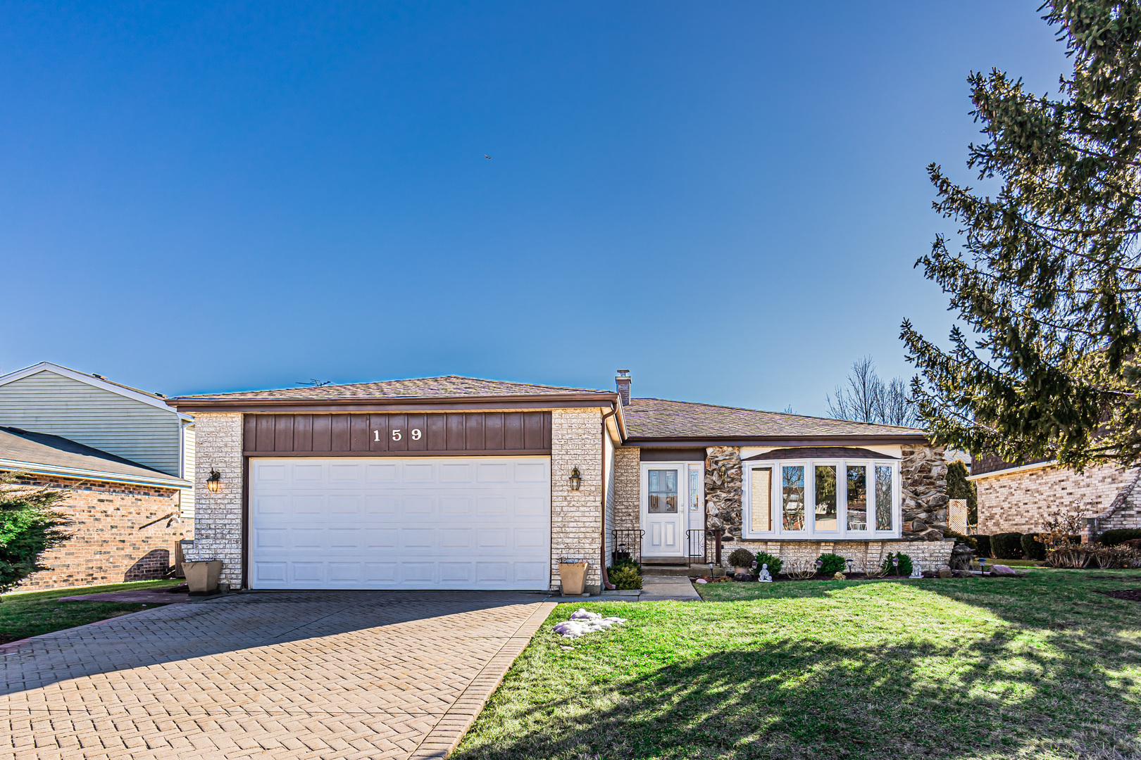 159 Harding Avenue Des Plaines, IL 60016 - Photo 1 of 44 a front view of a house with a garden and trees