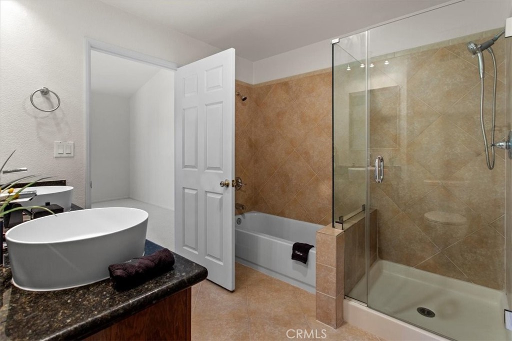 7230 Kelvin Avenue, Unit 6 Winnetka, CA 91306 - Photo 11 of 12 a bathroom with a granite countertop sink toilet and shower
