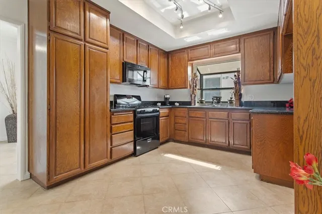 a kitchen with stainless steel appliances granite countertop a stove sink and cabinets