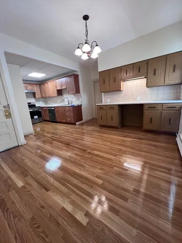 a view of a kitchen with stove and cabinets