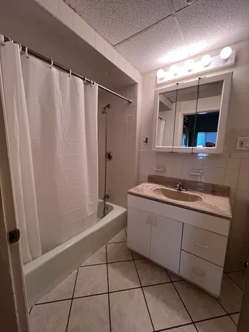 a bathroom with a sink a mirror and a bathtub