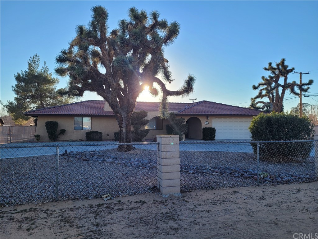 21111 Rancherias Road Apple Valley, CA 92307 - Photo 1 of 1 a front view of a house with garden