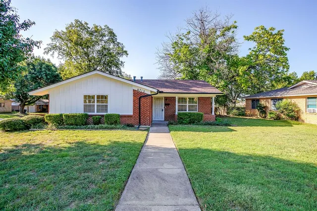 a front view of a house with yard