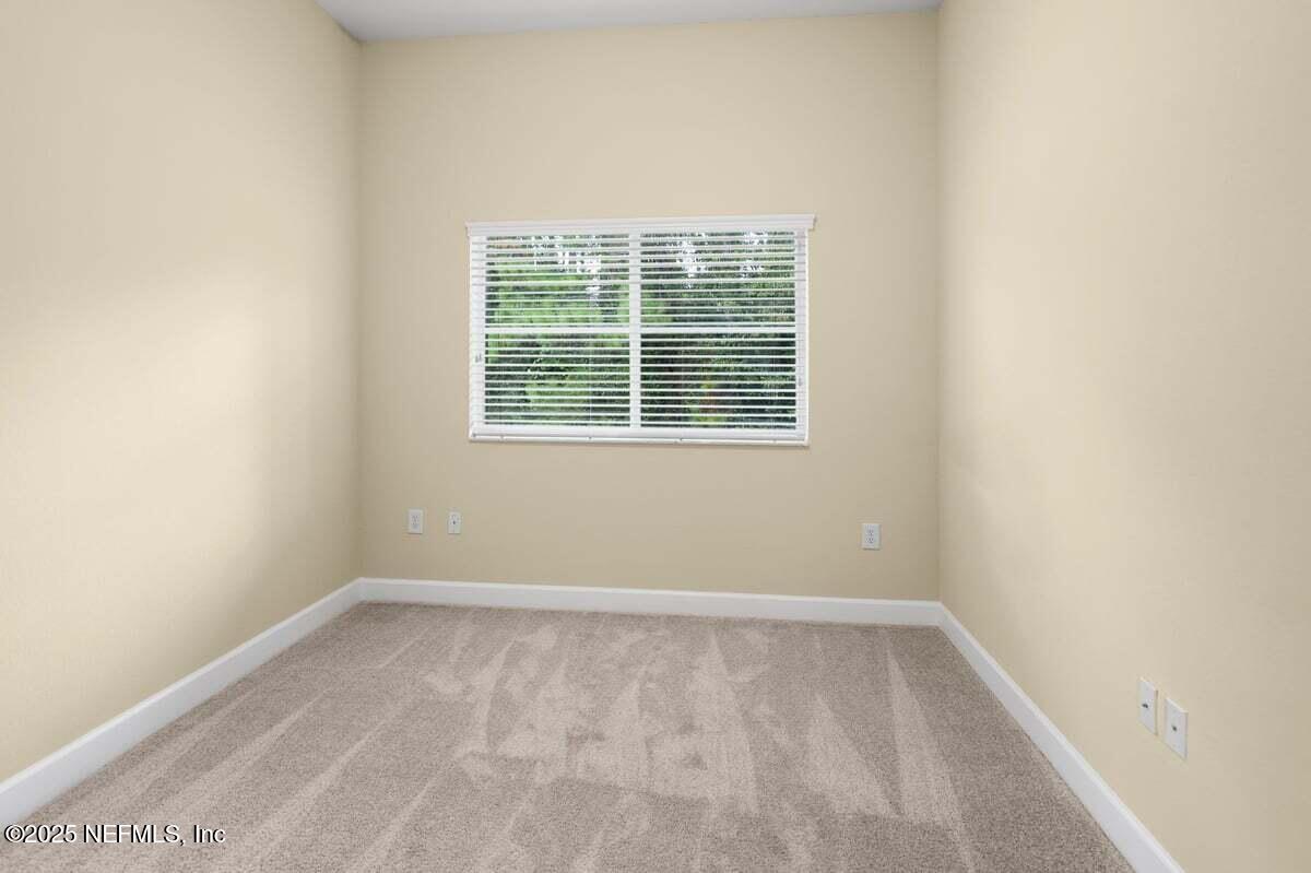 9745 Touchton Road, Unit 2421 Jacksonville, FL 32246 - Photo 12 of 26 an empty room with a window