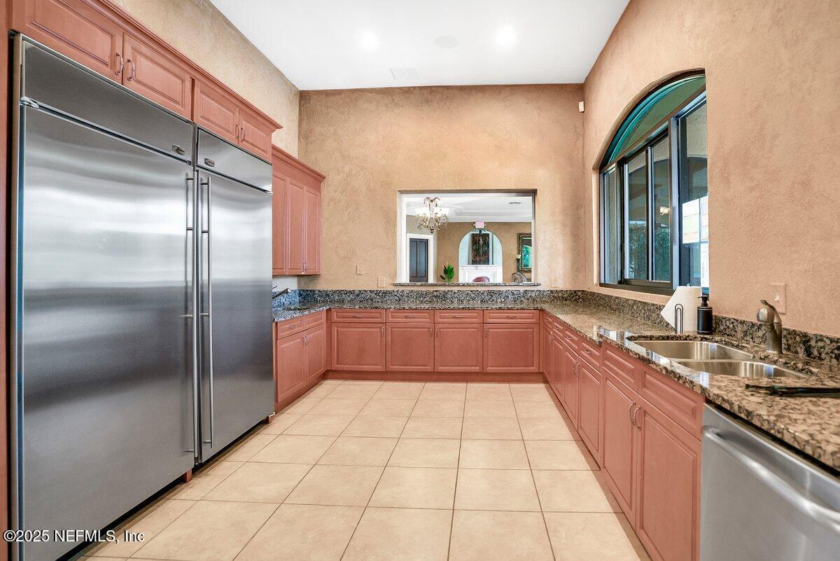 9745 Touchton Road, Unit 2421 Jacksonville, FL 32246 - Photo 17 of 26 a large kitchen with a large counter top a sink and stainless steel appliances