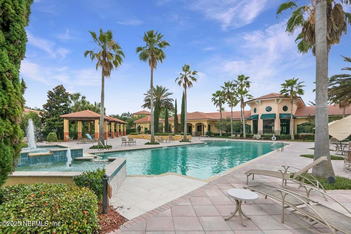 9745 Touchton Road, Unit 2421 Jacksonville, FL 32246 - Photo 19 of 26 a view of a house with a yard and potted plants