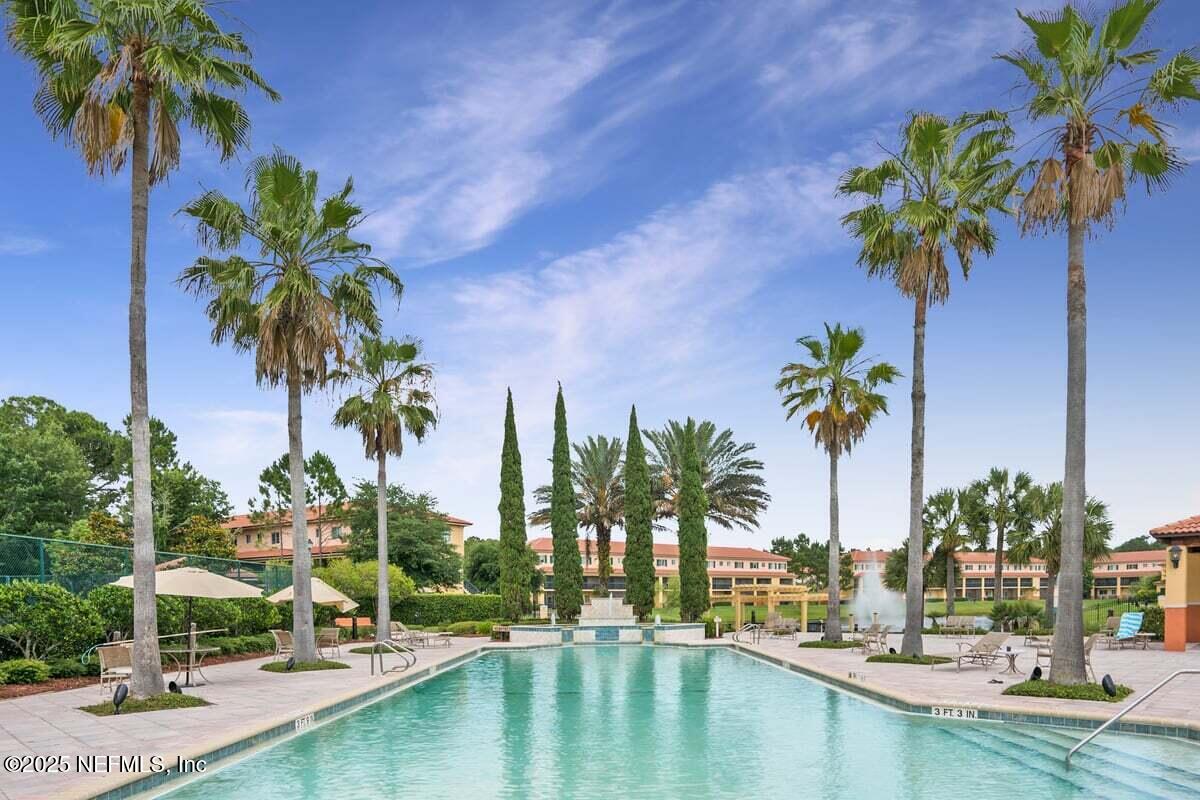 9745 Touchton Road, Unit 2421 Jacksonville, FL 32246 - Photo 20 of 26 a view of a swimming pool with a table and chairs