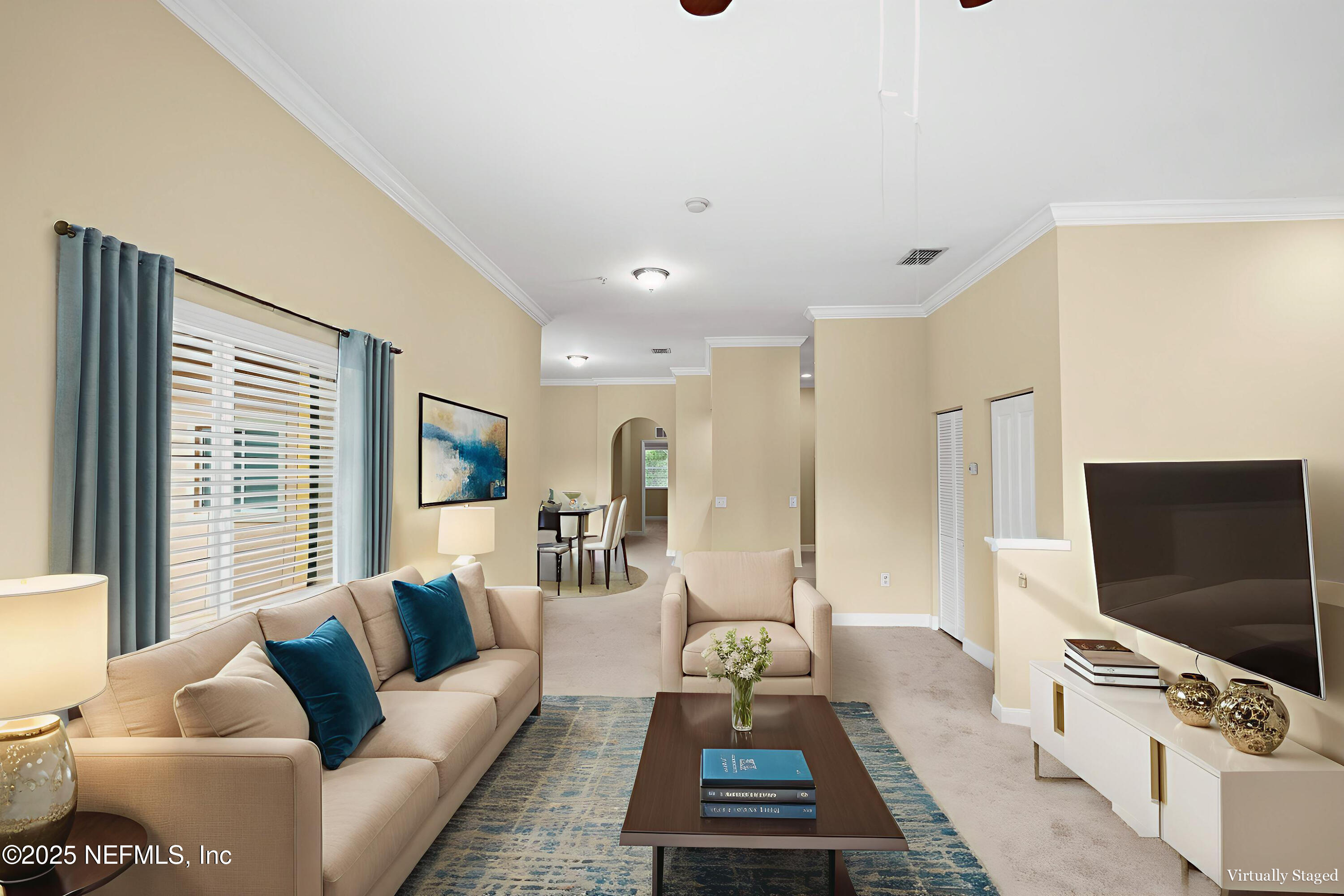 9745 Touchton Road, Unit 2421 Jacksonville, FL 32246 - Photo 5 of 26 a living room with furniture and a flat screen tv