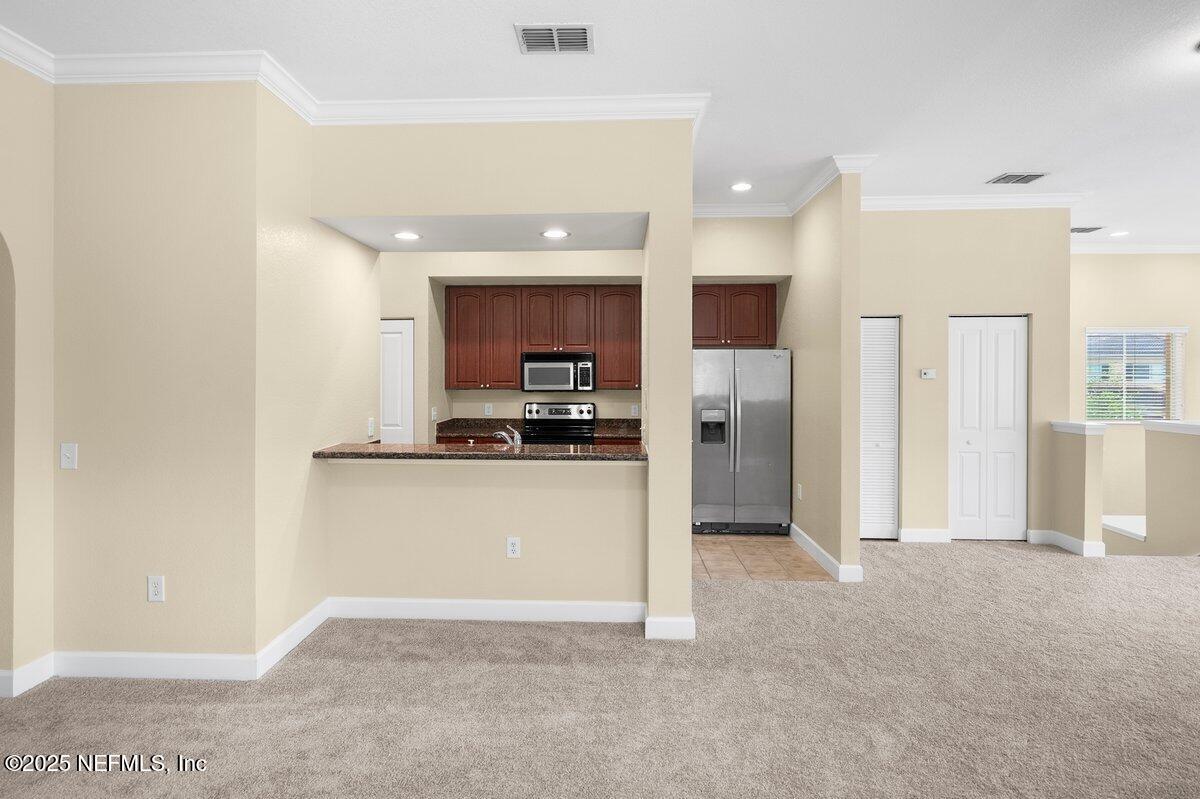 9745 Touchton Road, Unit 2421 Jacksonville, FL 32246 - Photo 9 of 26 a view of kitchen with refrigerator and window