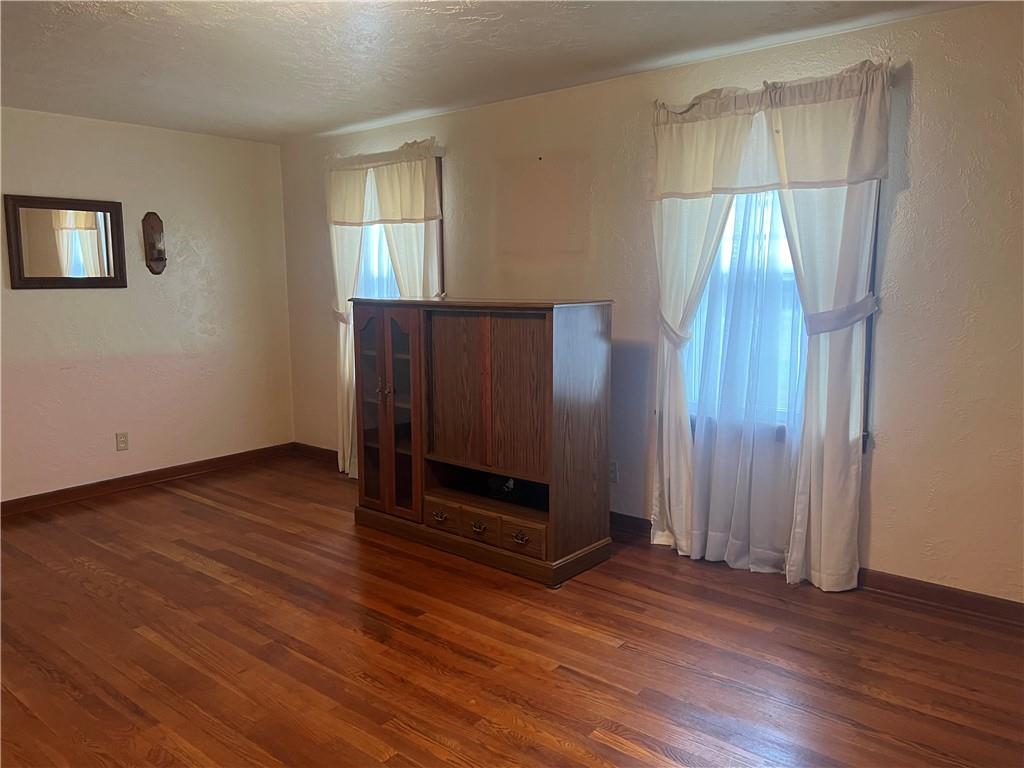 286 East Main Street Mount Pleasant, PA 15666 - Photo 18 of 30 an empty room with wooden floor mirror and windows