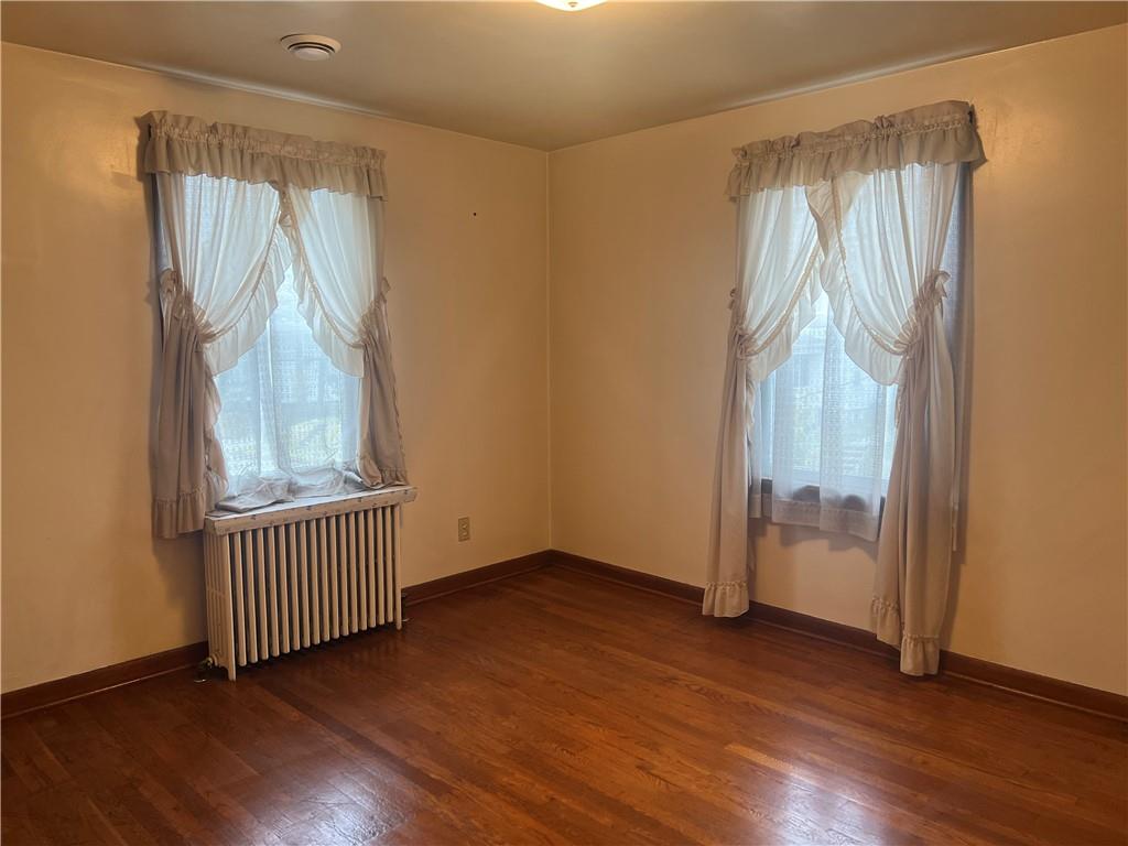 286 East Main Street Mount Pleasant, PA 15666 - Photo 22 of 30 an empty room with wooden floor and windows