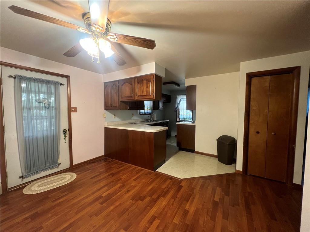 286 East Main Street Mount Pleasant, PA 15666 - Photo 6 of 30 a kitchen with stainless steel appliances granite countertop a refrigerator a stove top oven a sink and dishwasher with wooden floor