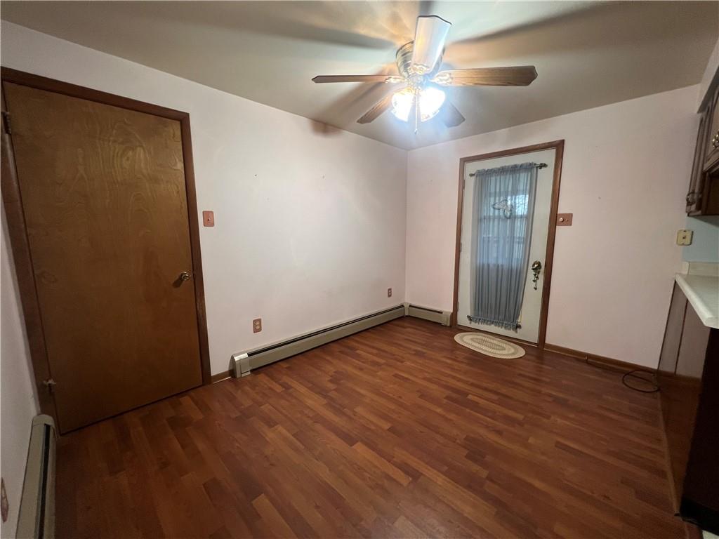 286 East Main Street Mount Pleasant, PA 15666 - Photo 7 of 30 a view of an empty room with wooden floor and a ceiling fan