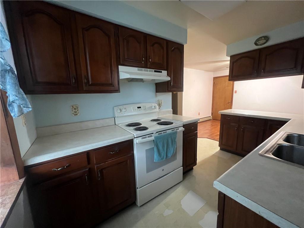 286 East Main Street Mount Pleasant, PA 15666 - Photo 8 of 30 a kitchen with stainless steel appliances wooden cabinets and a stove
