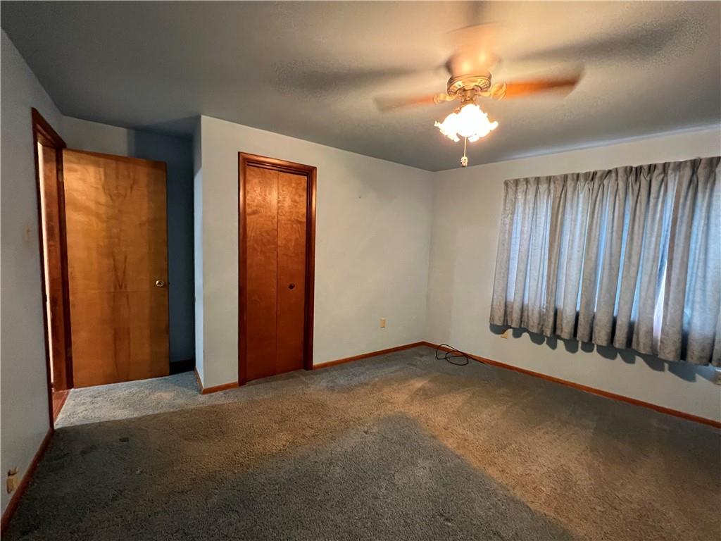 286 East Main Street Mount Pleasant, PA 15666 - Photo 10 of 30 an empty room with chandelier fan and windows