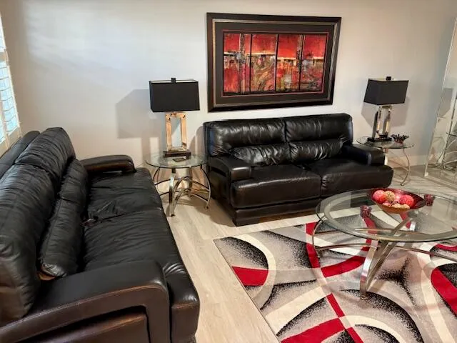 a living room with furniture and a floor to ceiling window