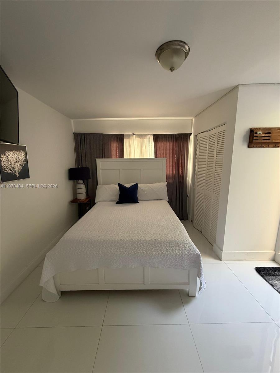 a bedroom with a bed and a walk in closet