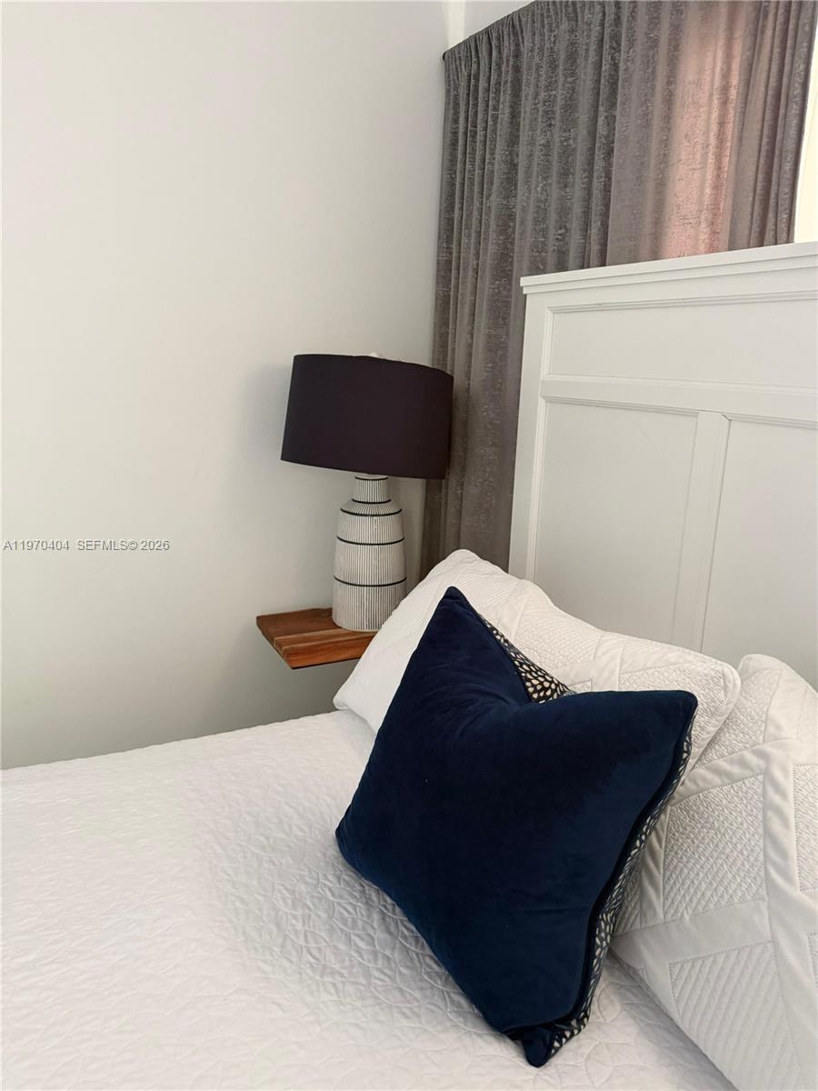 45 Southwest 28th Road Miami, FL 33129 - Photo 11 of 16 a bed sitting in a bedroom and chair