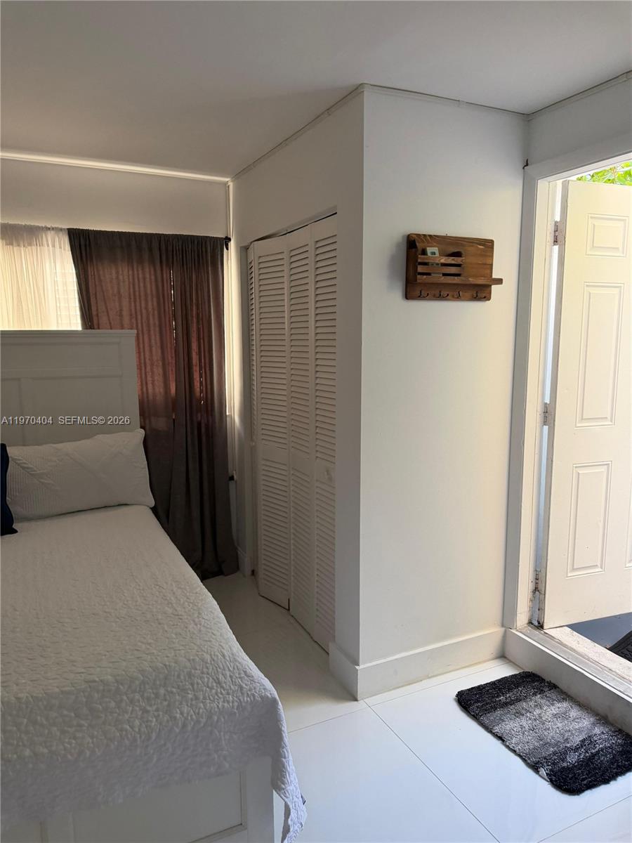 45 Southwest 28th Road Miami, FL 33129 - Photo 12 of 16 a bedroom with a bed and a window