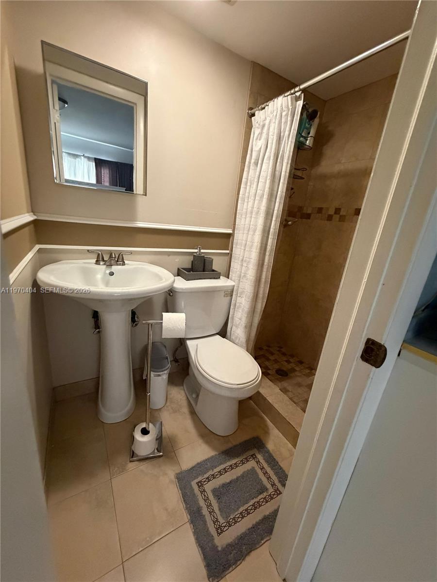 45 Southwest 28th Road Miami, FL 33129 - Photo 15 of 16 a bathroom with a sink toilet and shower