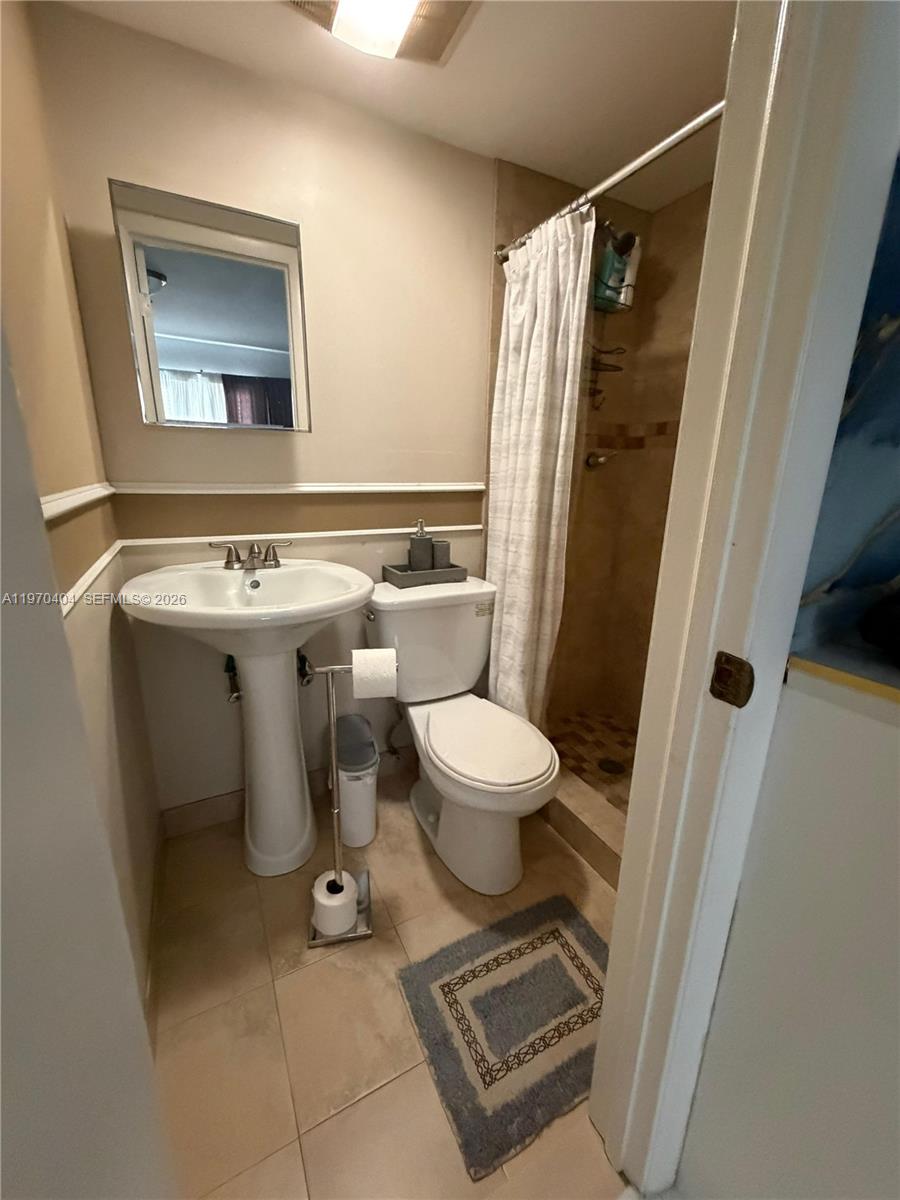 45 Southwest 28th Road Miami, FL 33129 - Photo 16 of 16 a bathroom with a toilet sink and mirror