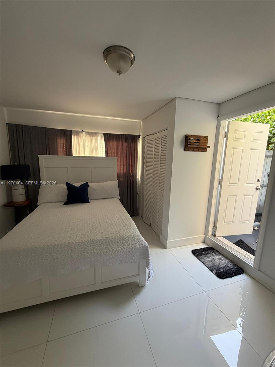 45 Southwest 28th Road Miami, FL 33129 - Photo 3 of 16 a bedroom with a large bed and a window