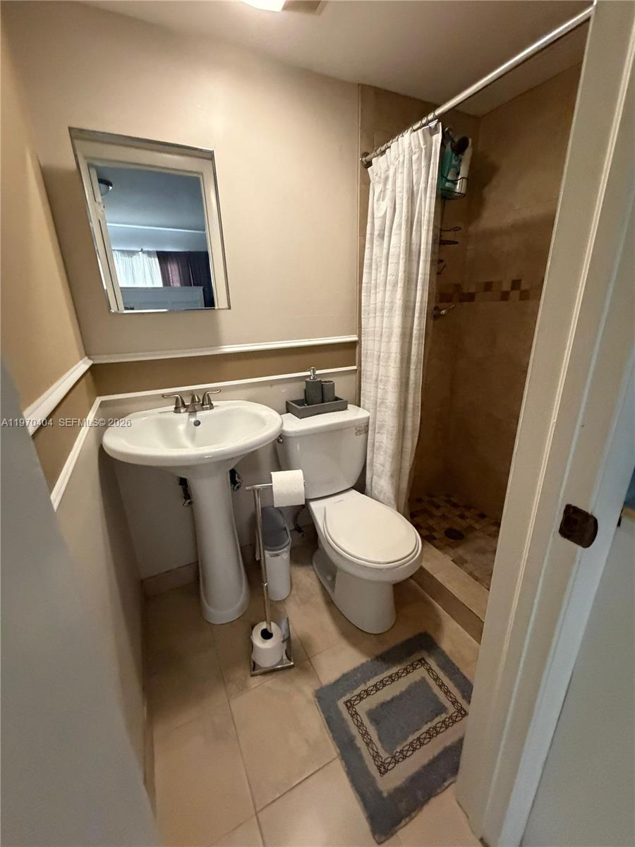 45 Southwest 28th Road Miami, FL 33129 - Photo 5 of 16 a bathroom with a toilet sink and shower