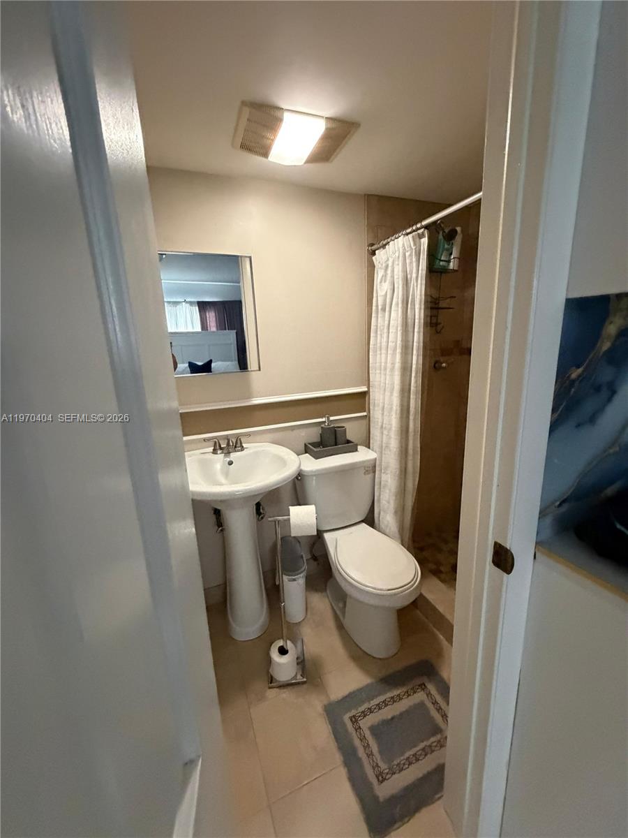 45 Southwest 28th Road Miami, FL 33129 - Photo 6 of 16 a bathroom with a toilet sink and shower