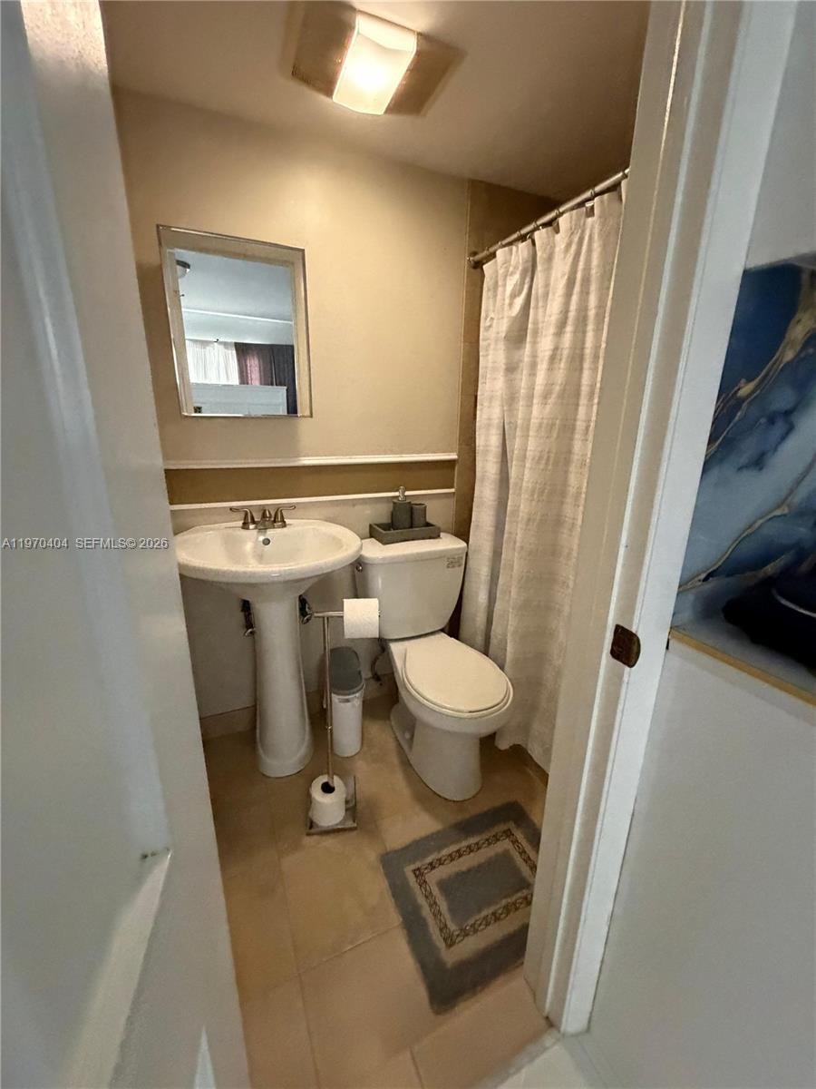 45 Southwest 28th Road Miami, FL 33129 - Photo 9 of 16 a bathroom with a toilet sink and a mirror