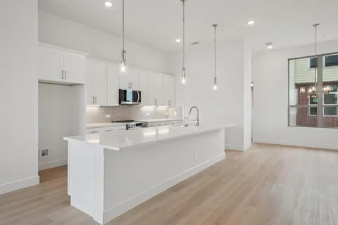a kitchen with kitchen island a sink stainless steel appliances and a counter top