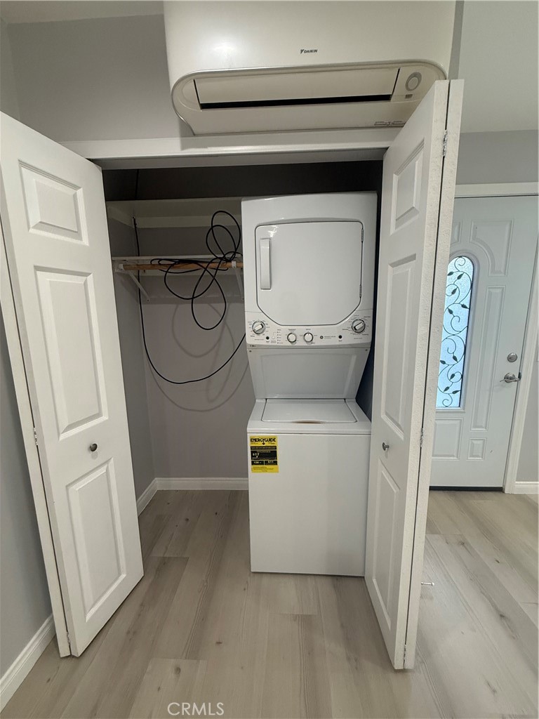 6504 Hesperia Avenue Reseda, CA 91335 - Photo 6 of 11 a utility room with closet and wooden floor