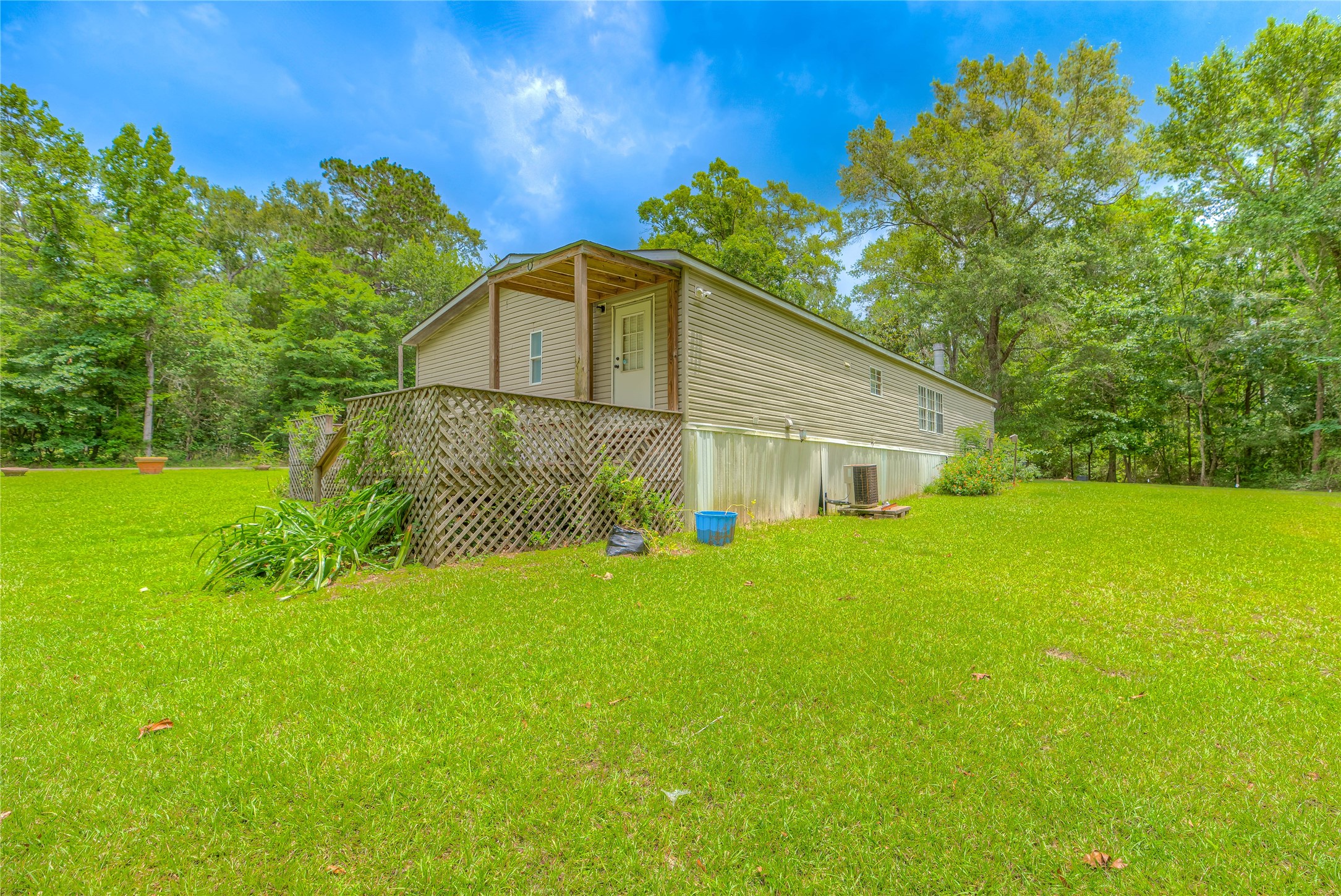657 Parrish Road Livingston, TX 77351 - Photo 24 of 47 a yellow house with a yard
