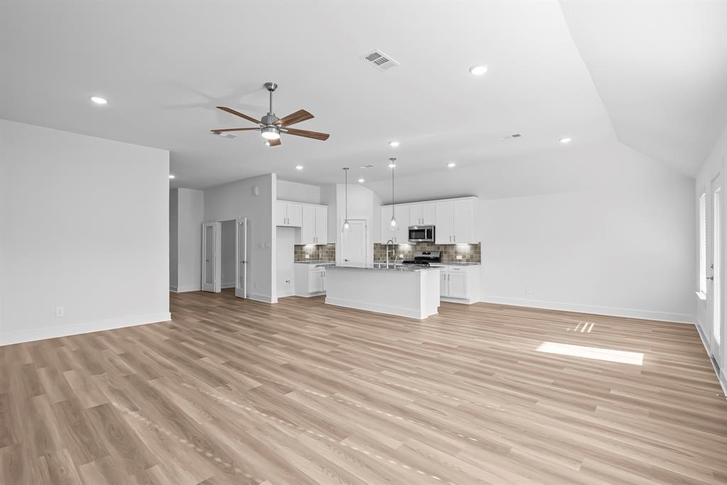 562 Bluebell Maiden Court Magnolia, TX 77354 - Photo 3 of 13 a view of kitchen with granite countertop cabinets and refrigerator