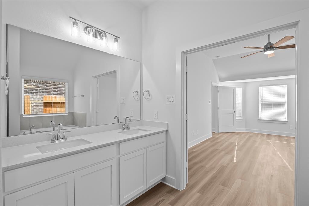 562 Bluebell Maiden Court Magnolia, TX 77354 - Photo 10 of 13 a bathroom with a double vanity sink and mirror