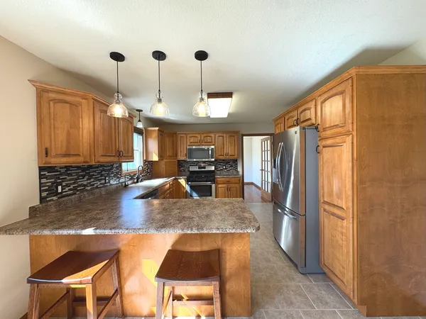 a view of a livingroom with wooden floor and a fireplace