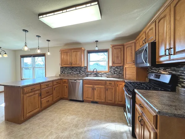 an empty room with windows and ceiling fan