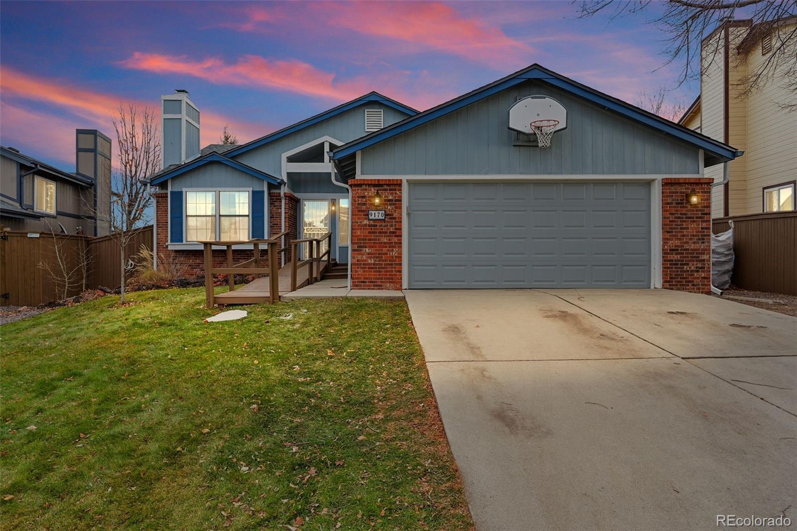 a view of a house with a yard and garage