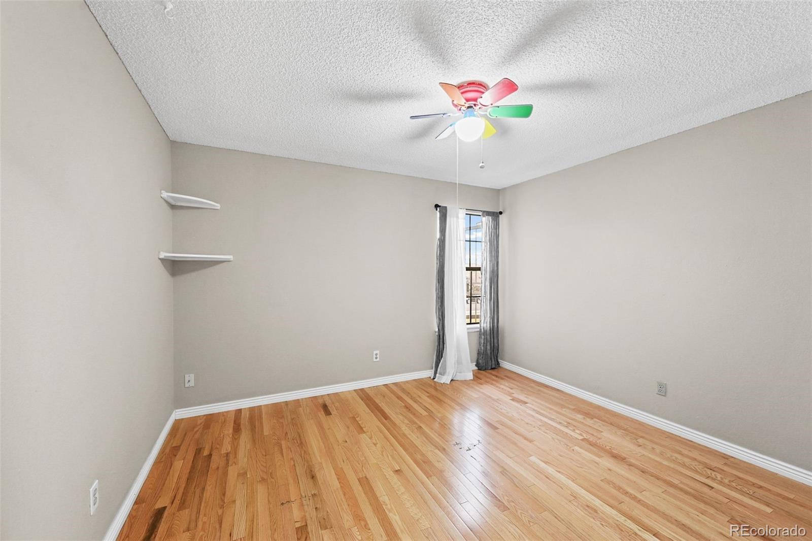 9170 Stargrass Circle Highlands Ranch, CO 80126 - Photo 23 of 39 wooden floor in an empty room with a window