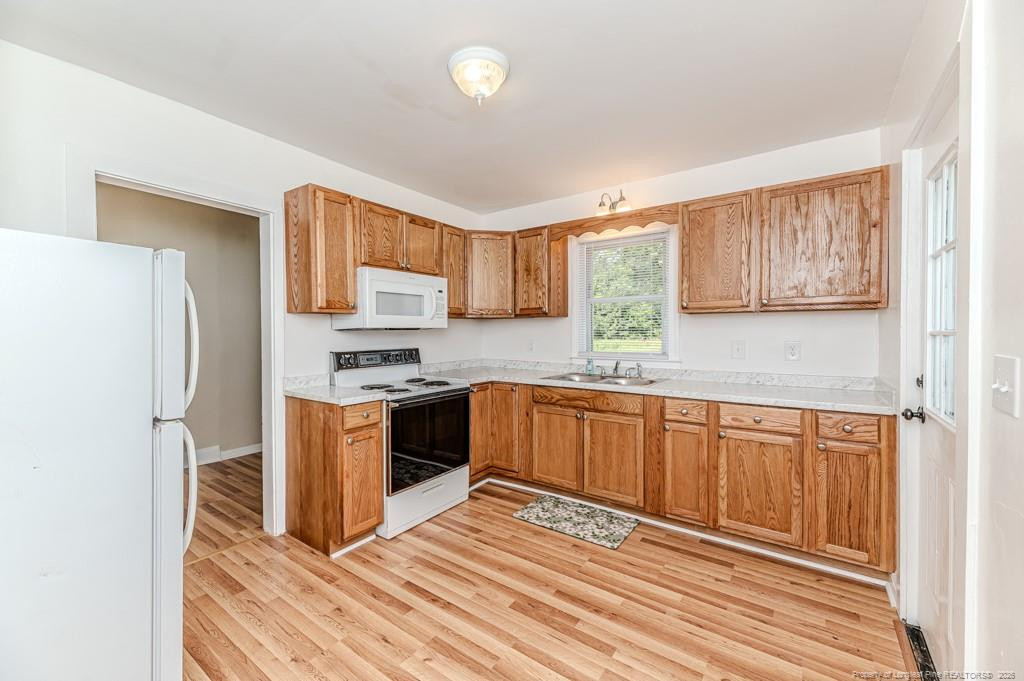 222 St Andrews Church Road Sanford, NC 27332 - Photo 12 of 24 a kitchen with stainless steel appliances granite countertop a refrigerator sink and stove