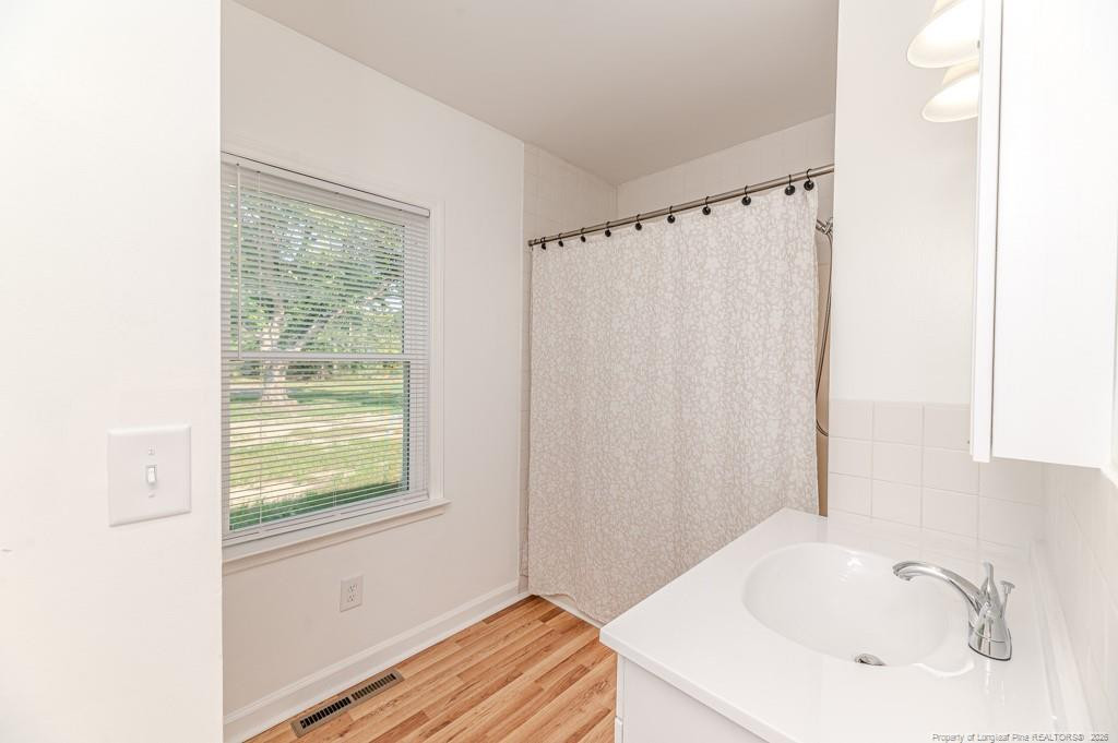 222 St Andrews Church Road Sanford, NC 27332 - Photo 14 of 24 a bathroom with a sink and a window