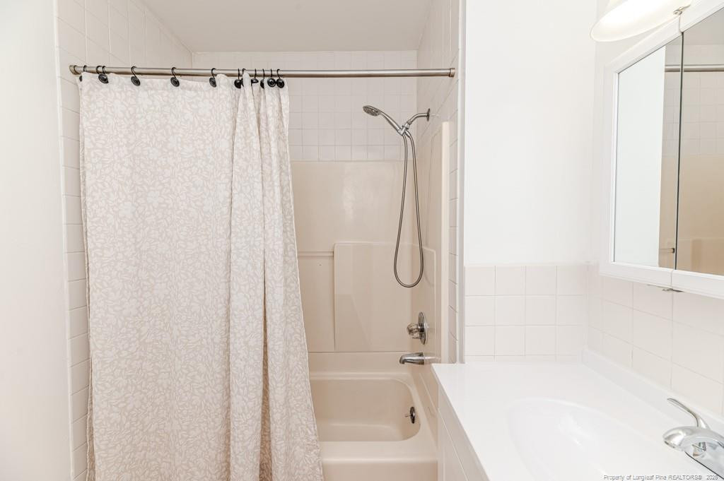 222 St Andrews Church Road Sanford, NC 27332 - Photo 16 of 24 a bathroom with a bathtub and a shower
