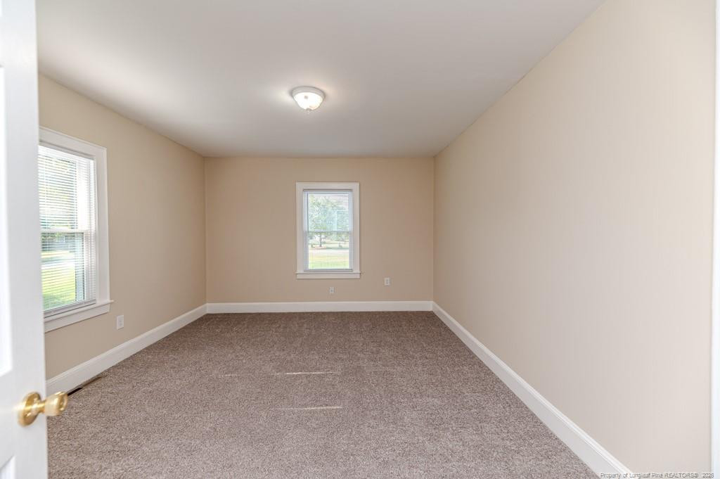 222 St Andrews Church Road Sanford, NC 27332 - Photo 21 of 24 an empty room with windows